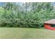 Backyard with a large grassy area and lots of beautiful, mature trees at 1148 Woodland Cir, Lawrenceville, GA 30043