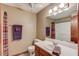 Bathroom features a clean vanity, mirror, and shower-tub combination at 1148 Woodland Cir, Lawrenceville, GA 30043