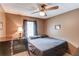 Bedroom with a dark bedset, dresser, ceiling fan, and natural lighting at 1148 Woodland Cir, Lawrenceville, GA 30043
