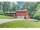 Two-story home with a front-facing, two-car garage and extended driveway on landscaped lot at 1148 Woodland Cir, Lawrenceville, GA 30043