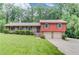 Charming home with a well-manicured lawn and attached two-car garage at 1148 Woodland Cir, Lawrenceville, GA 30043
