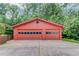 Two-car garage with a row of windows and a large concrete driveway at 1148 Woodland Cir, Lawrenceville, GA 30043