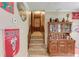 Upstairs hallway with carpeted stairs, unique decorations, and a wooden cabinet at 1148 Woodland Cir, Lawrenceville, GA 30043