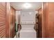Stacked washer and dryer in laundry room with wood walls and tile flooring at 1148 Woodland Cir, Lawrenceville, GA 30043