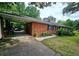 A single story brick home with car port and landscaped yard at 2480 Sewell Mill Rd, Marietta, GA 30062
