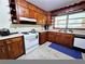 Traditional kitchen features wooden cabinets, white appliances, and marble-like tile flooring at 2480 Sewell Mill Rd, Marietta, GA 30062
