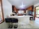A traditional kitchen features wooden cabinets, a peninsula bar, and tile flooring at 2480 Sewell Mill Rd, Marietta, GA 30062
