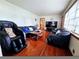 Cozy living room with hardwood floors, comfortable seating, and ample natural light at 2480 Sewell Mill Rd, Marietta, GA 30062