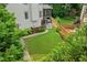 A large backyard with a green lawn, a patio, and mature landscaping at 435 Ruby Forest Pkwy, Suwanee, GA 30024