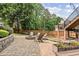 Backyard with paver patio, fire pit, retaining wall, and stairs to the second story deck at 435 Ruby Forest Pkwy, Suwanee, GA 30024