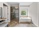 Bathroom features tiled floor, glass shower, soaking tub, and vanity area at 435 Ruby Forest Pkwy, Suwanee, GA 30024