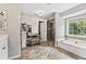 Bright bathroom boasts a soaking tub, tiled floors, glass shower, and vanity area at 435 Ruby Forest Pkwy, Suwanee, GA 30024