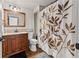 Bathroom with wood-style vanity, coordinating fixtures, and decorative shower curtain at 435 Ruby Forest Pkwy, Suwanee, GA 30024