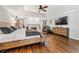 Spacious main bedroom with hardwood floors, fireplace, sitting area, and large dresser at 435 Ruby Forest Pkwy, Suwanee, GA 30024