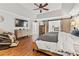 Spacious main bedroom with hardwood floors, TV, dresser and sliding barn doors to bathroom at 435 Ruby Forest Pkwy, Suwanee, GA 30024