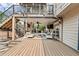 Multi-level deck features an outdoor kitchen, seating, and string lights for evening entertaining at 435 Ruby Forest Pkwy, Suwanee, GA 30024
