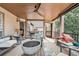 Cozy covered deck with ceiling fan, an outdoor fireplace, and a view of the backyard at 435 Ruby Forest Pkwy, Suwanee, GA 30024