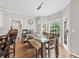 Sunlit dining area with modern light fixture, view of the yard, and hardwood flooring at 435 Ruby Forest Pkwy, Suwanee, GA 30024