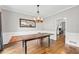 Elegant dining room featuring hardwood floors, wainscoting, and a rustic chandelier over the dining table at 435 Ruby Forest Pkwy, Suwanee, GA 30024