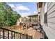 Exterior view of a two-story house with a spacious deck, steps, and outdoor lighting at 435 Ruby Forest Pkwy, Suwanee, GA 30024