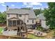 Two-story house boasts a spacious deck, a landscaped backyard, and mature trees at 435 Ruby Forest Pkwy, Suwanee, GA 30024