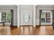 Bright foyer with hardwood floors, white trim, and a decorative front door that floods the space with natural light at 435 Ruby Forest Pkwy, Suwanee, GA 30024