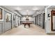 Expansive game room showcasing a pool table, built-in bookshelves, and stylish decor at 435 Ruby Forest Pkwy, Suwanee, GA 30024