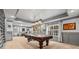 Spacious game room with a pool table, large windows, and stylish gray trim work at 435 Ruby Forest Pkwy, Suwanee, GA 30024