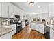 Bright, eat-in kitchen featuring white cabinets, granite countertops, stainless steel appliances, and hardwood floors at 435 Ruby Forest Pkwy, Suwanee, GA 30024