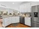 Well-lit kitchen with white cabinetry, granite countertops, and stainless steel appliances at 435 Ruby Forest Pkwy, Suwanee, GA 30024