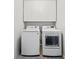 Bright laundry room with white washer, dryer, and cabinetry above appliances for organized storage at 435 Ruby Forest Pkwy, Suwanee, GA 30024