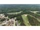 Aerial view of a neighborhood situated around a golf course, lake, and lush green landscape at 50 Worthington Dr, Villa Rica, GA 30180