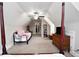 Attic bedroom featuring a four poster bed, dormer, and twin bed at 50 Worthington Dr, Villa Rica, GA 30180