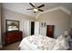 Comfortable bedroom with a ceiling fan, crown molding, and traditional wood furniture at 50 Worthington Dr, Villa Rica, GA 30180