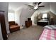Attic bedroom featuring a four poster bed, easy chair, and dormer at 50 Worthington Dr, Villa Rica, GA 30180
