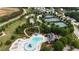 Aerial view of the community pool, waterslide, splash pad, tennis courts, and clubhouse at 50 Worthington Dr, Villa Rica, GA 30180