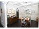 Elegant dining room with coffered ceilings, dark wood floors, and stylish chandelier at 50 Worthington Dr, Villa Rica, GA 30180