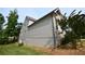 Side view of the home showcasing the home's siding, stone accents, and well-maintained landscaping at 50 Worthington Dr, Villa Rica, GA 30180