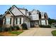 Beautiful two-story home featuring a stone facade, garage and lush landscaping at 50 Worthington Dr, Villa Rica, GA 30180
