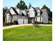Charming two-story home featuring a well-manicured lawn, two-car garage, and stone accents at 50 Worthington Dr, Villa Rica, GA 30180