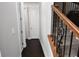 Hallway featuring hardwood floors, stairs and white walls at 50 Worthington Dr, Villa Rica, GA 30180