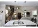 Bright open floor plan showcasing kitchen island with sink, and a view into the living area and staircase at 50 Worthington Dr, Villa Rica, GA 30180