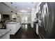 Gourmet kitchen features stainless steel appliances and island with granite countertops, with door to the patio at 50 Worthington Dr, Villa Rica, GA 30180