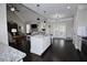 Modern kitchen with granite island, open layout to living area, and abundant natural light at 50 Worthington Dr, Villa Rica, GA 30180