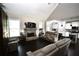 Open-concept living room featuring a stone fireplace, hardwood floors, and access to a modern kitchen at 50 Worthington Dr, Villa Rica, GA 30180
