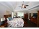 Bright main bedroom with a floral comforter and a window letting in light at 50 Worthington Dr, Villa Rica, GA 30180