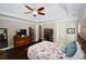 Comfortable main bedroom featuring a ceiling fan, dresser and a sliding door leading to the bathroom at 50 Worthington Dr, Villa Rica, GA 30180