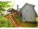 Back exterior view of home, featuring a deck, screened porch, stairs, and low maintenance landscaping at 50 Worthington Dr, Villa Rica, GA 30180