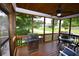 A lovely screened porch with an outdoor grill and comfortable seating area overlooks the lush backyard at 50 Worthington Dr, Villa Rica, GA 30180