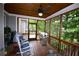 Relaxing screened porch featuring a ceiling fan, wood ceiling, grill, and comfortable rocking chairs at 50 Worthington Dr, Villa Rica, GA 30180
